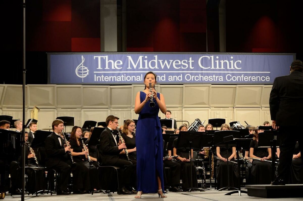 girl playing clarinet on stage